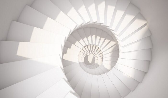 Above view of white spiral staircase, representing the "upward spiral" of change, from article: What is change.