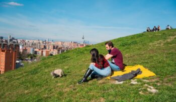 Couple sitting on a hillside in Spain