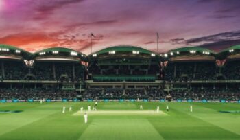 Cricket match in stadium at night