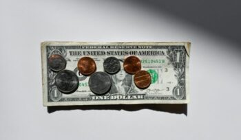 Dollar bill and coins|caleb wright unsplash