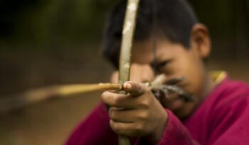 Guarani child holding bow