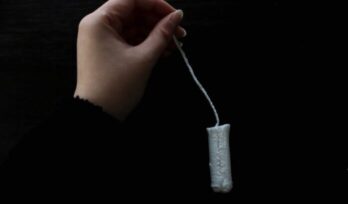 Hand holding tampon