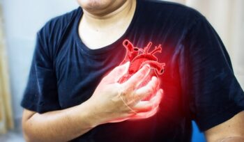 Man clutching his chest from acute pain