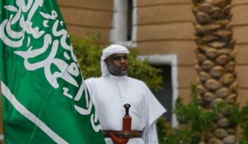 Man holding Saudi Arabia flag