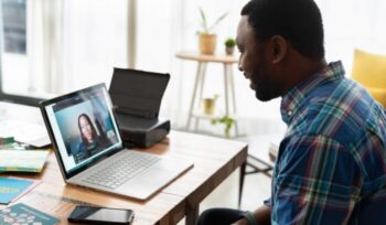 Man on laptop video conference