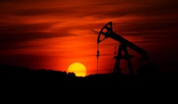 Pump-jack mining crude oil at sunset