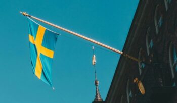 Swedish flag hanging from a building|Stockholm