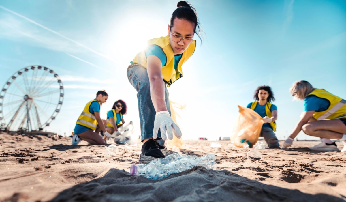 A team of volunteers picking up trash off the beach