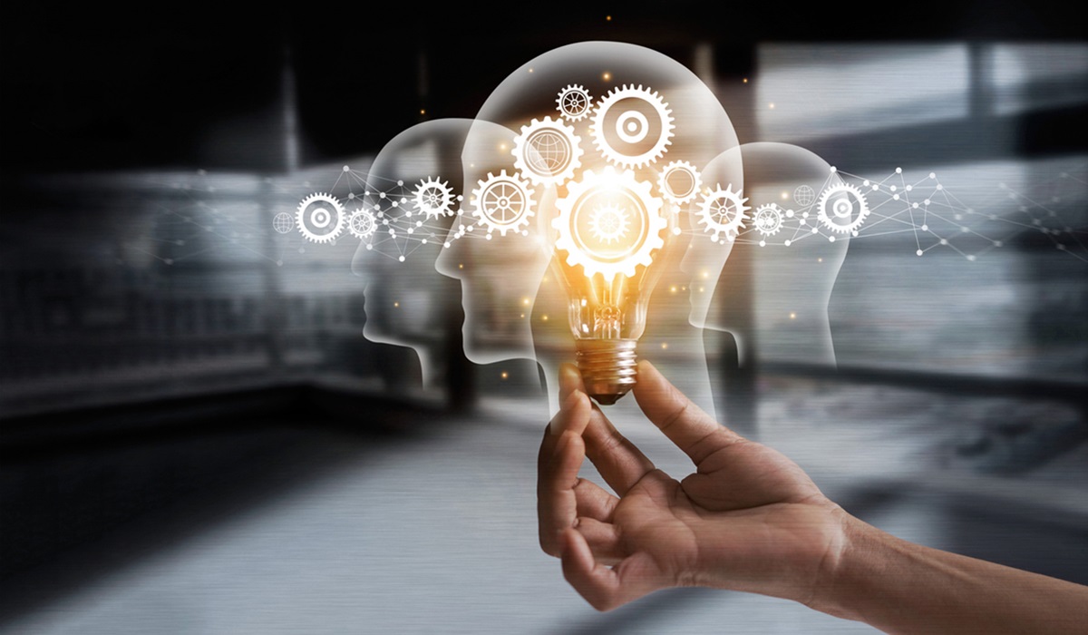 an illustration of a light bulb lit up with gears