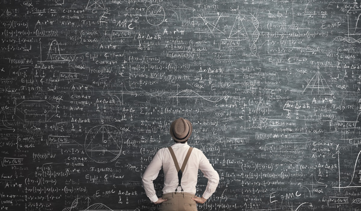 A man in front of a huge, complicated chalk board full of equations, representing trying to save the world through intellect