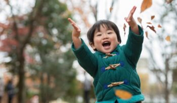 child and autumn leaves