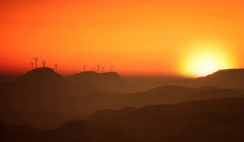 Wind turbines in the distance at sunrise