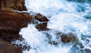 Sea water crashing against rocks